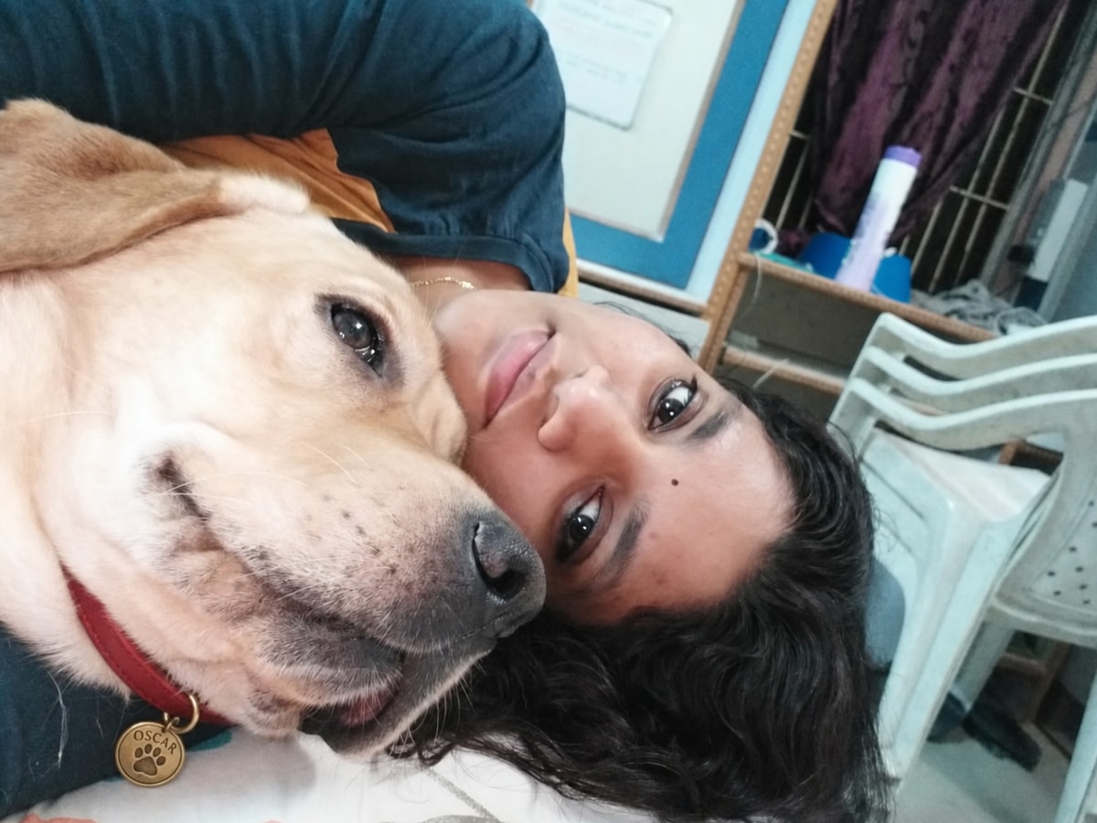 Oscar cuddling contentedly beside a member of his family